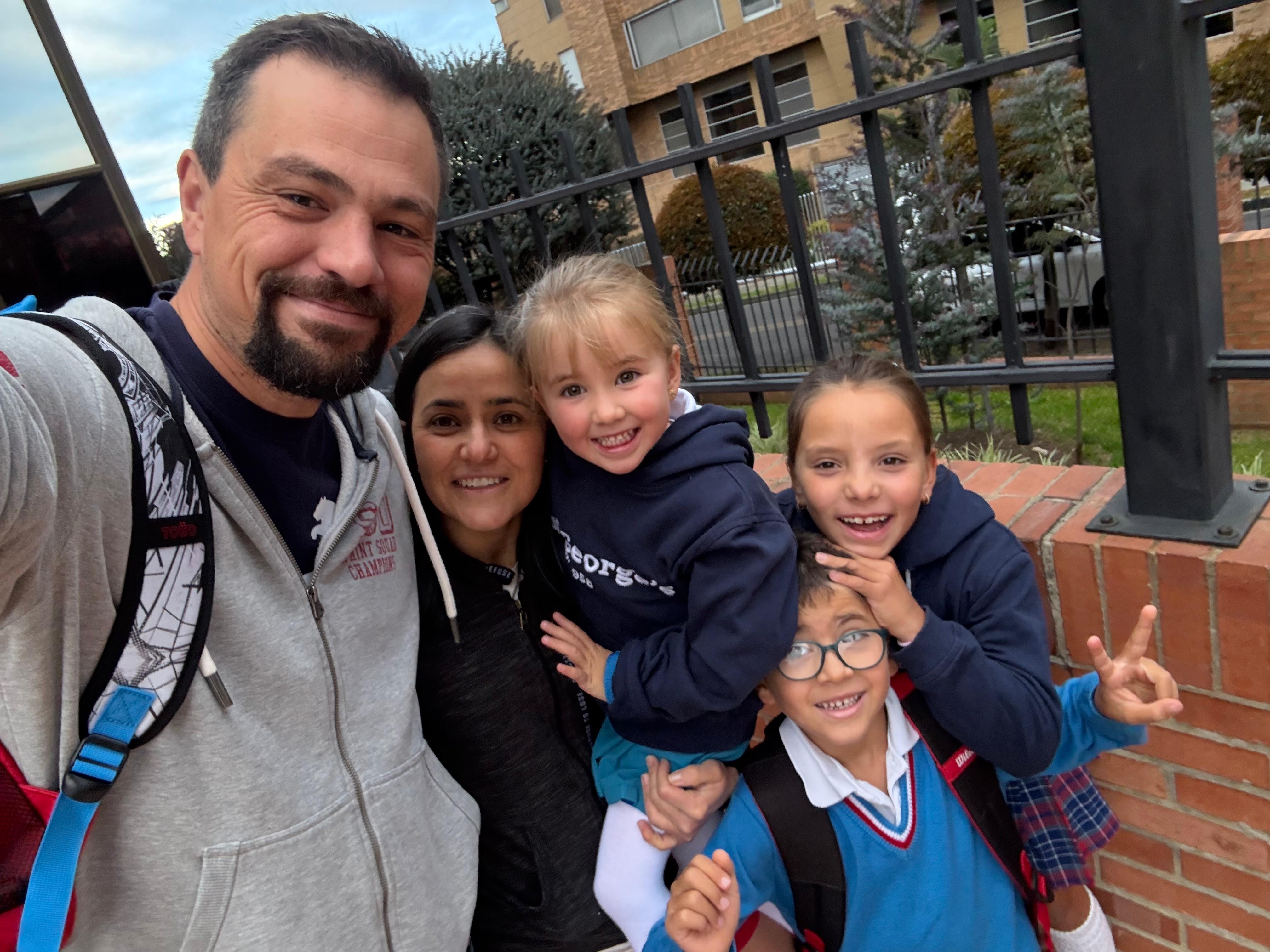 Alejandra with Anthony and their three children outside the school gates